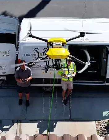 Cleaning drone being guided by a ground crew
