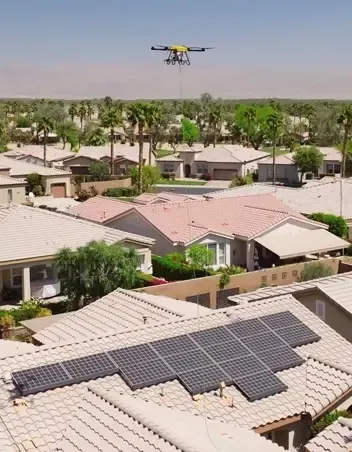 Cleaning drone flying over a utility-scale solar farm