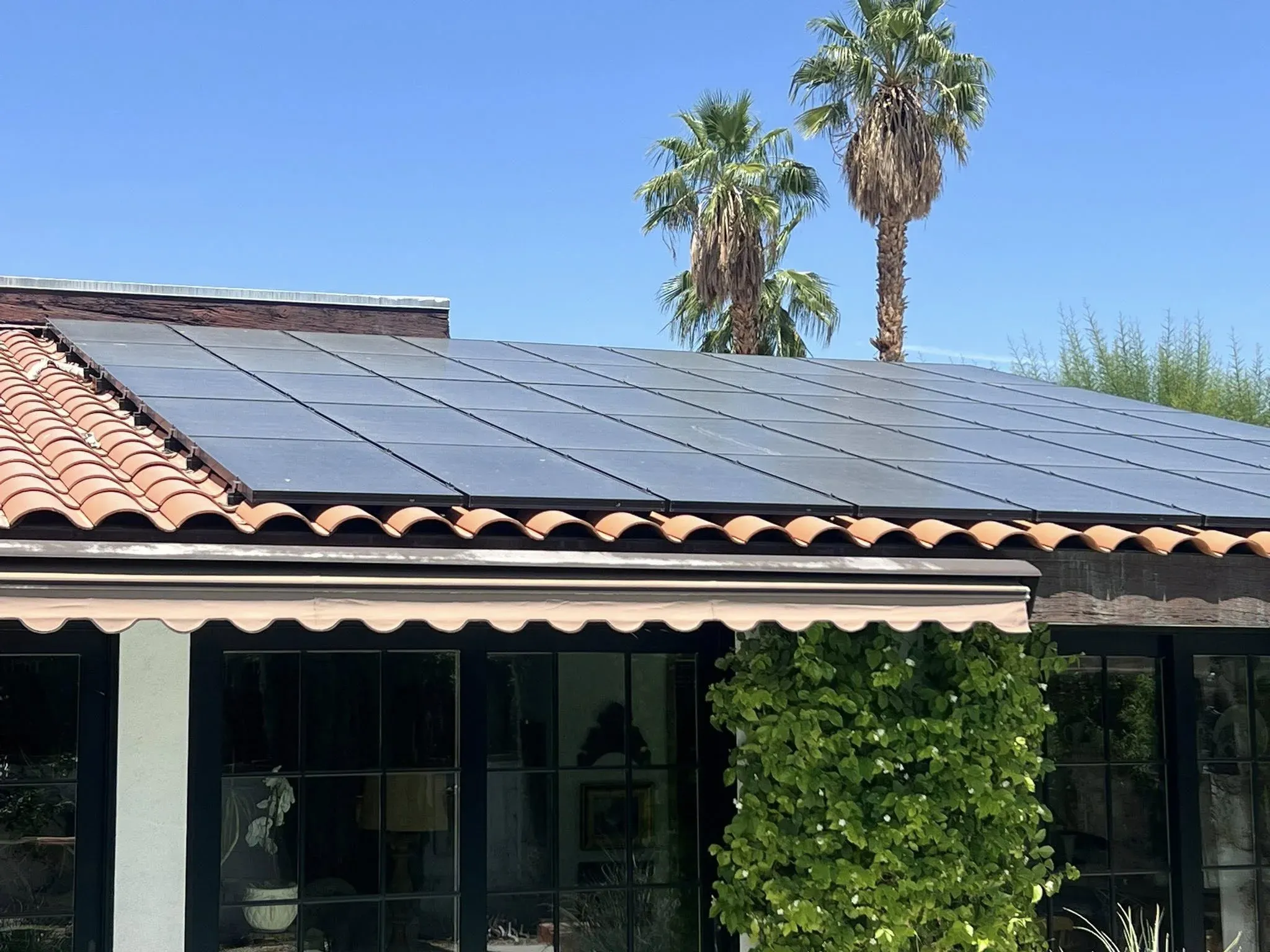 Rooftop solar array coated in desert dust and grime before a DronePower1 drone cleaning pass