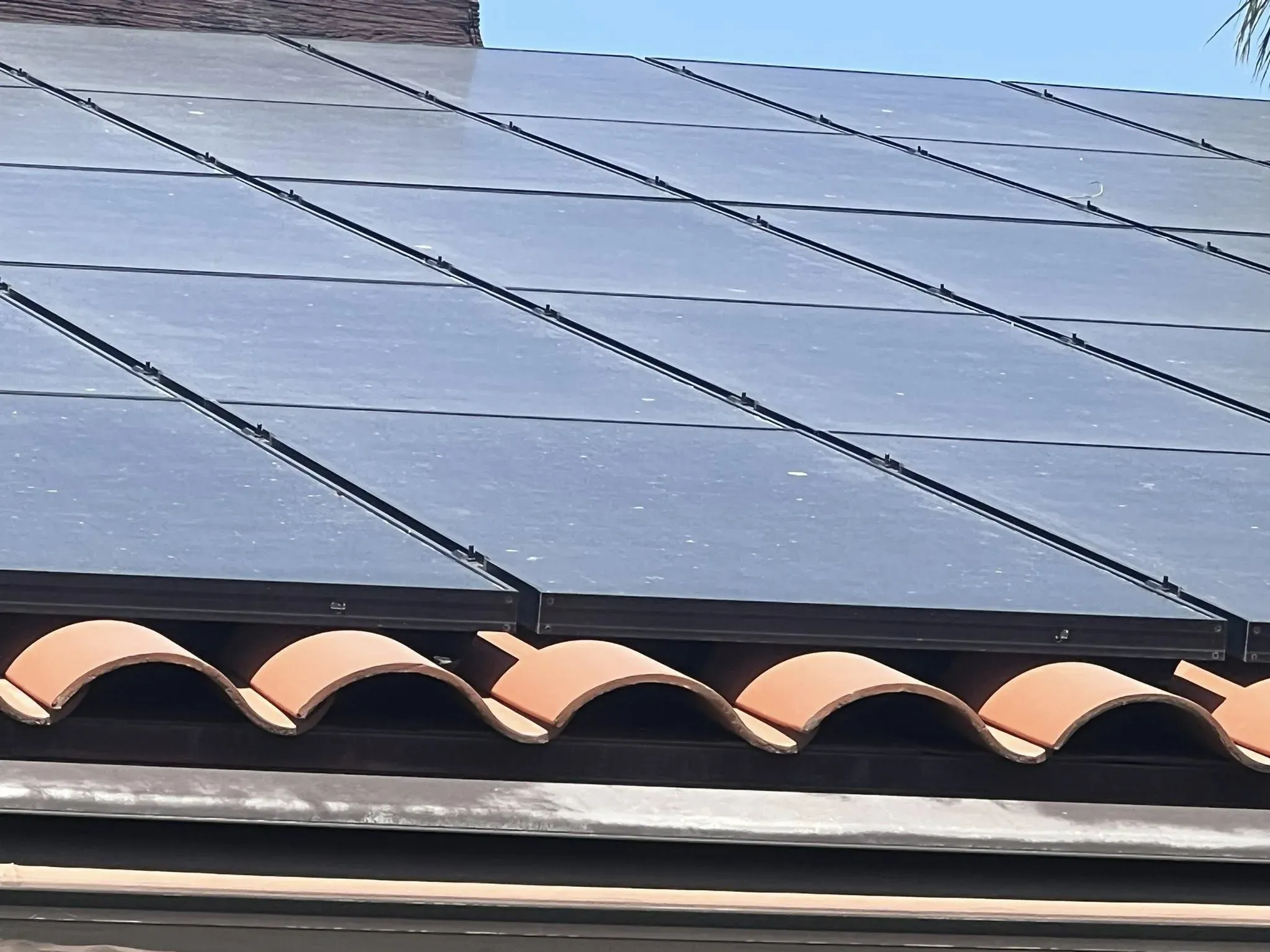 Close rooftop view of solar panels dulled by dust before a DronePower1 cleaning