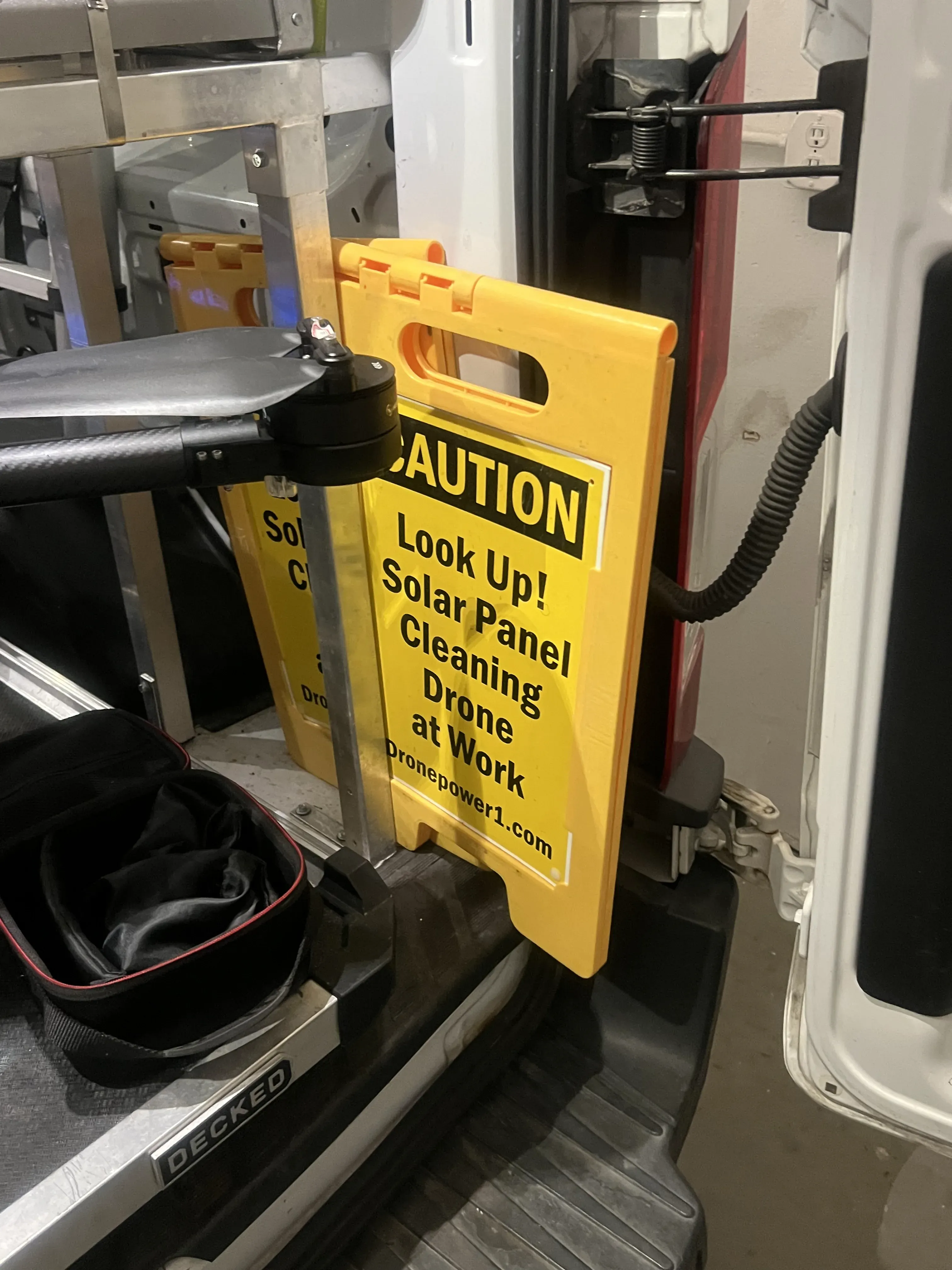 Bright yellow caution sign used to mark the work area