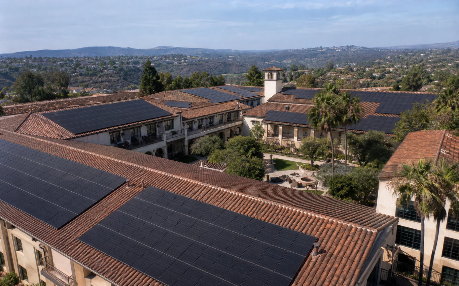 Large solar arrays across the Spanish tile roofs of a Rancho Santa Fe commercial property