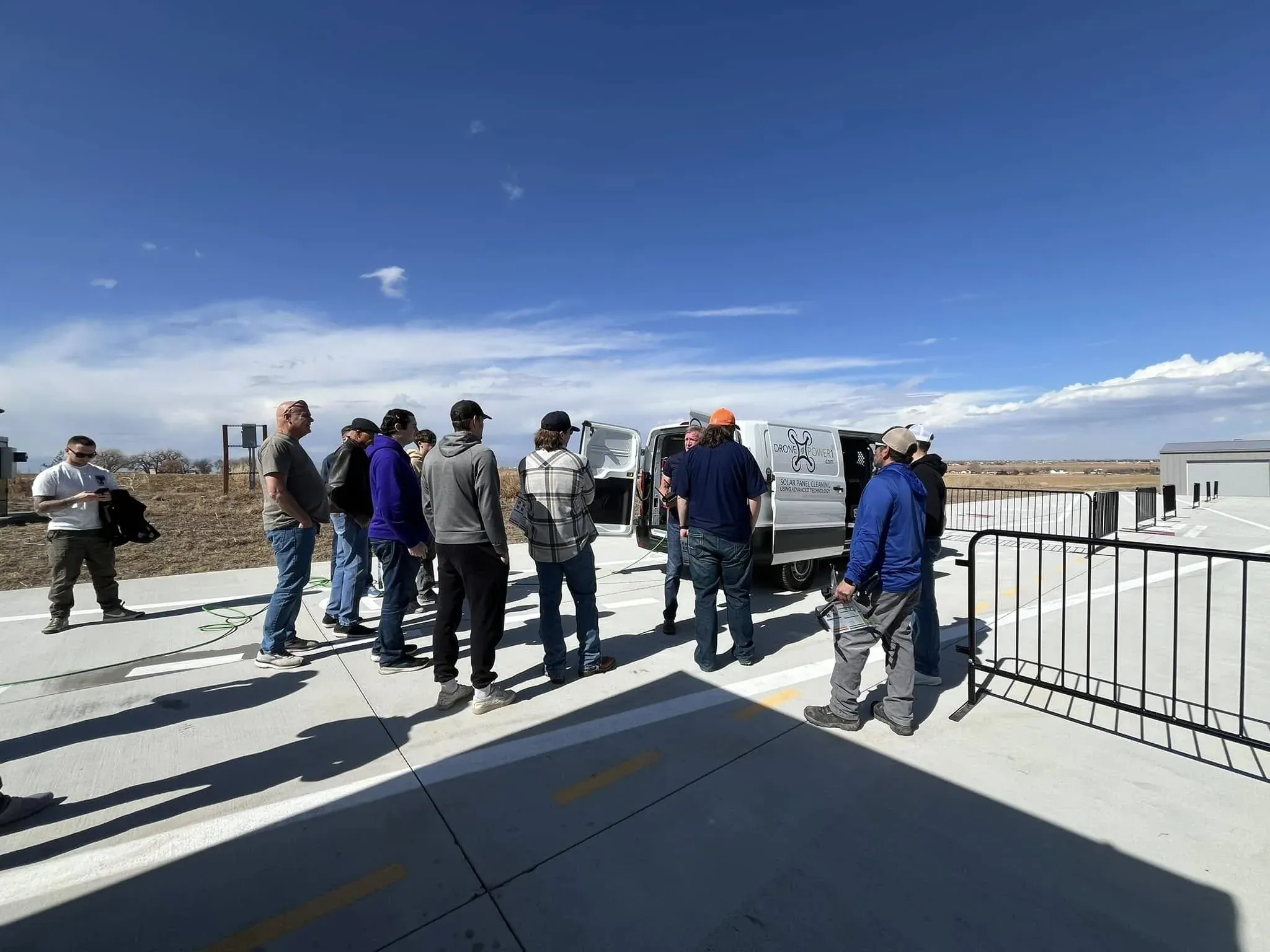 DronePower1 crew gathered on a rooftop next to the branded work van