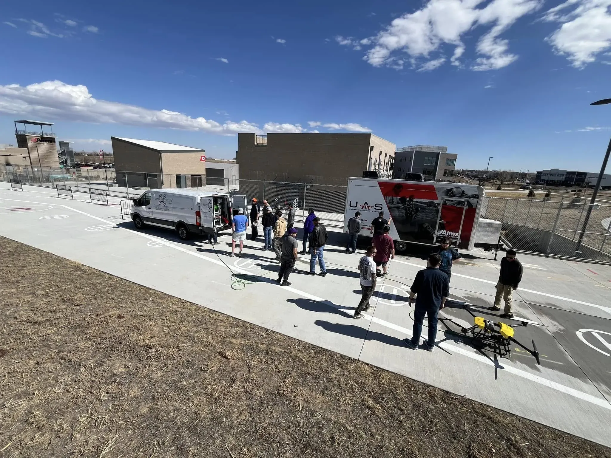 DronePower1 crew running a jobsite briefing with cleaning equipment staged nearby
