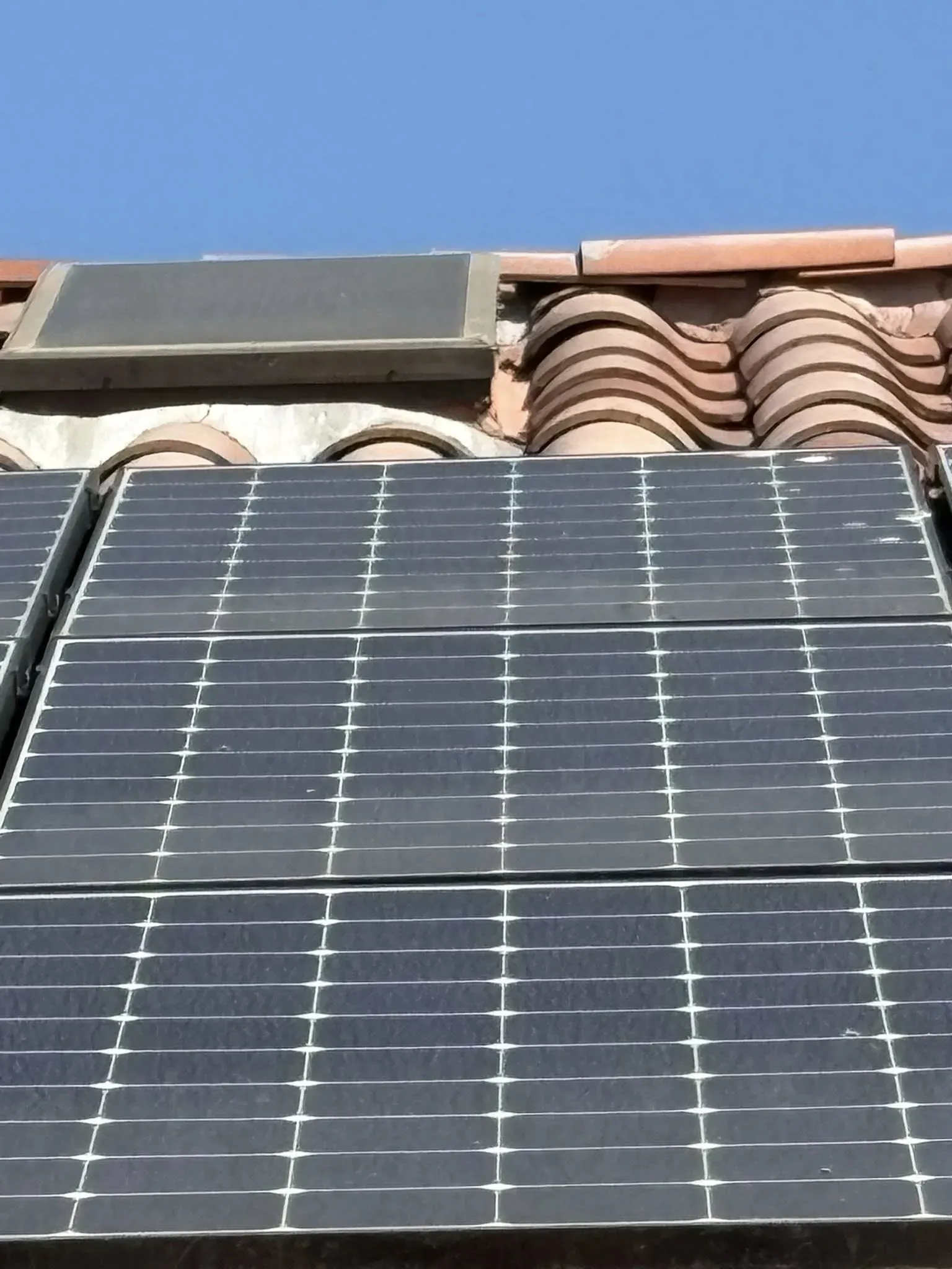 Vertical front-facing close-up of a rooftop solar panel run