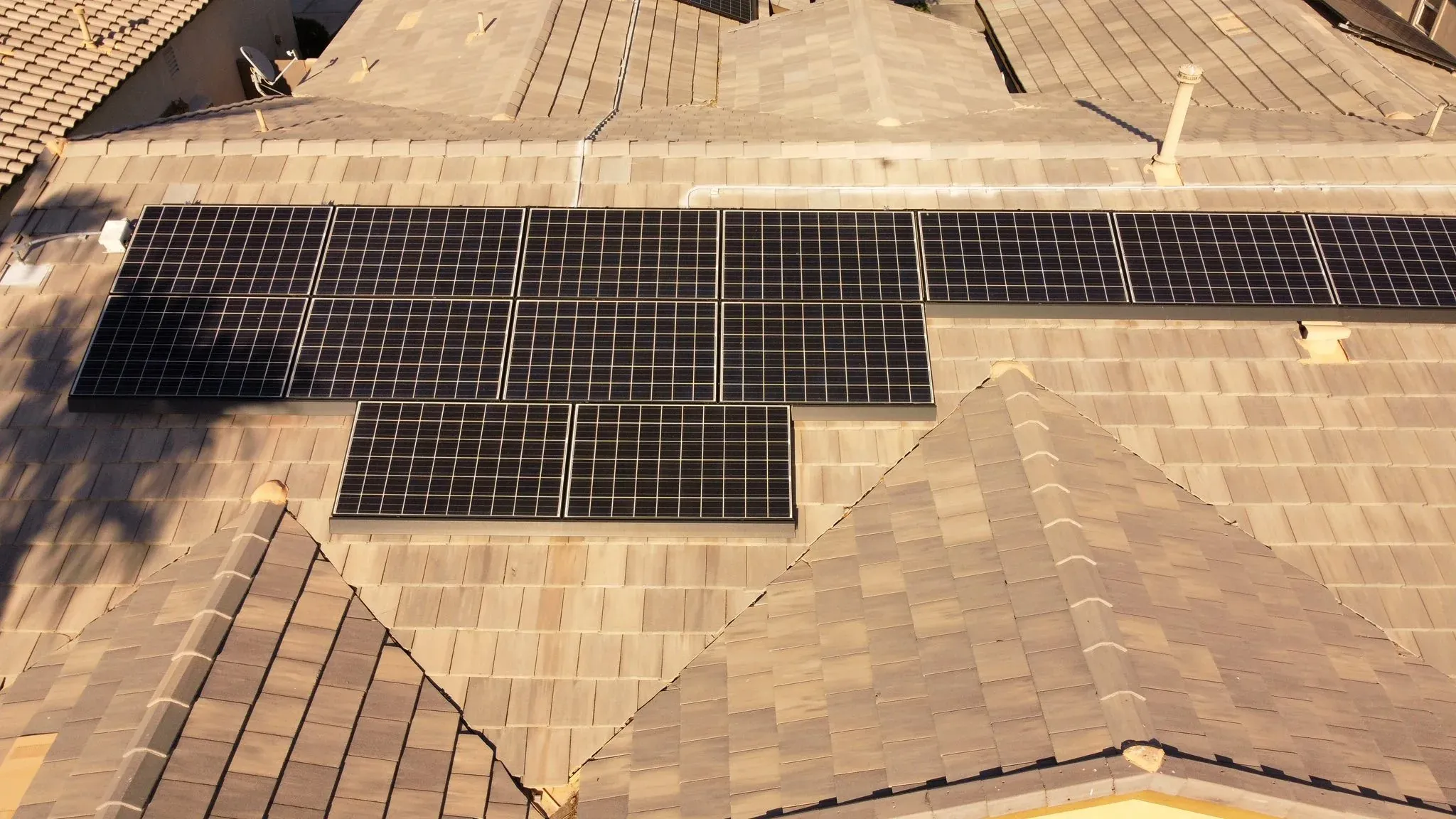 Wide overhead roof shot with solar panels and open sky