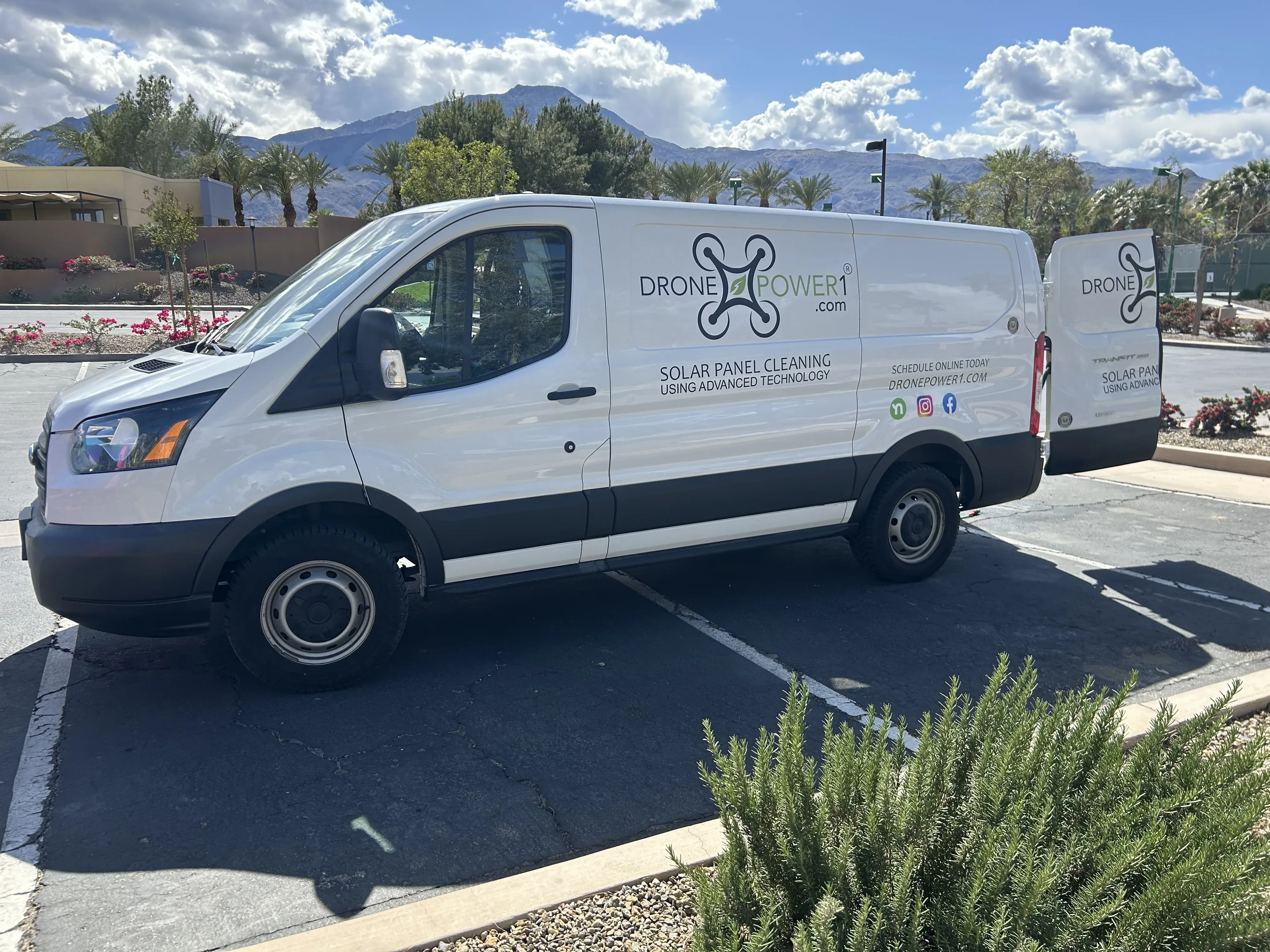 DronePower1 work van parked at a job with branding visible on the side