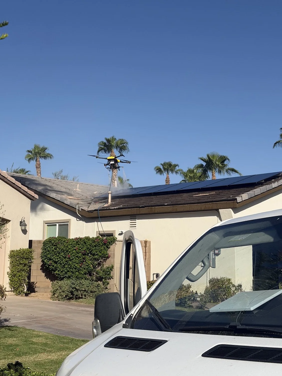 DronePower1 cleaning rooftop solar panels at a customer's home